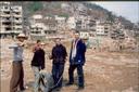 All of us trying to create some kind of construction-related pose with the shell of a town behind us.